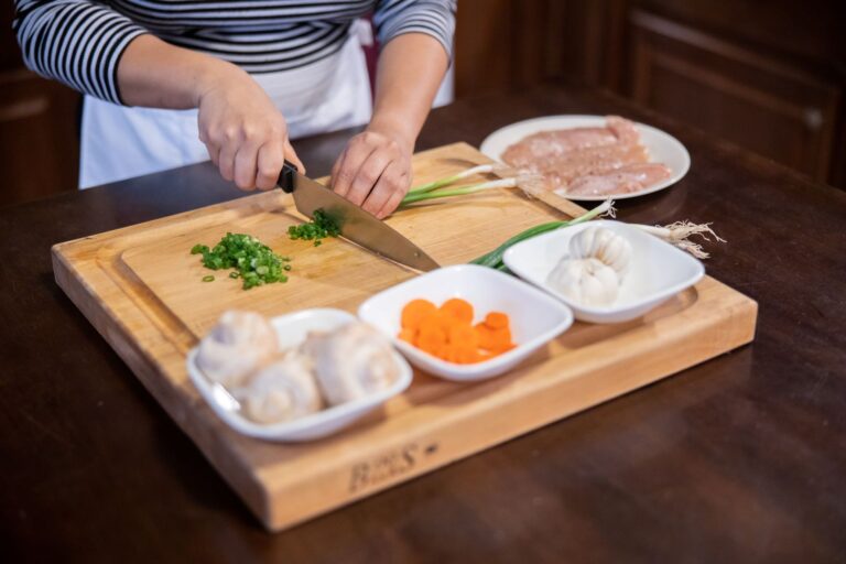 cutting board with ingredients being cut on it