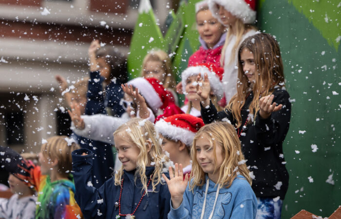 Holiday parade kids on a float with fake snow