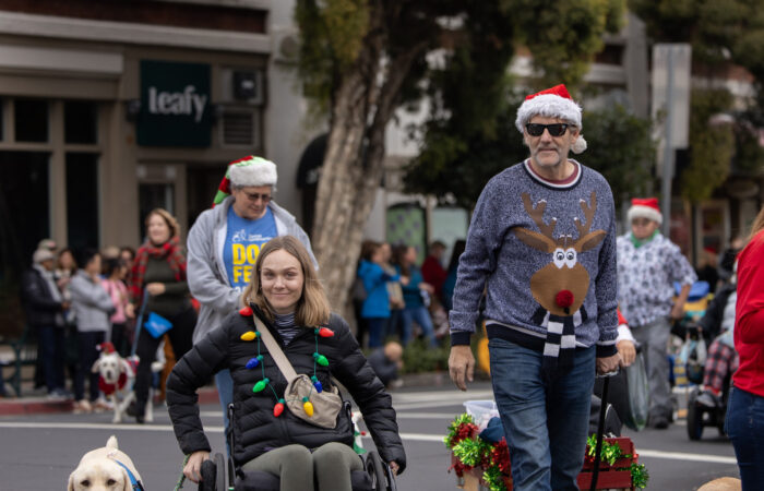 Holiday parade guide dog and girl in a wheelchair