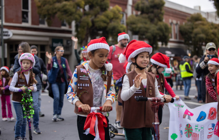 Holiday parade girl scouts on scooters