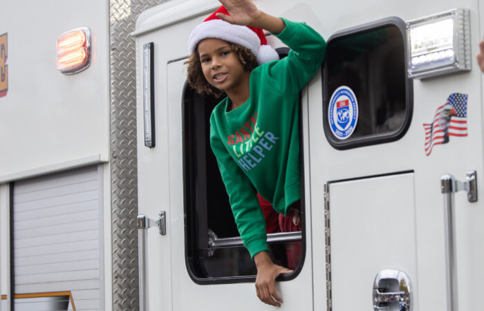 Holiday Parade kid on a firetruck