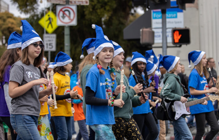 Holiday Parade kids with recorders and blue santa hats