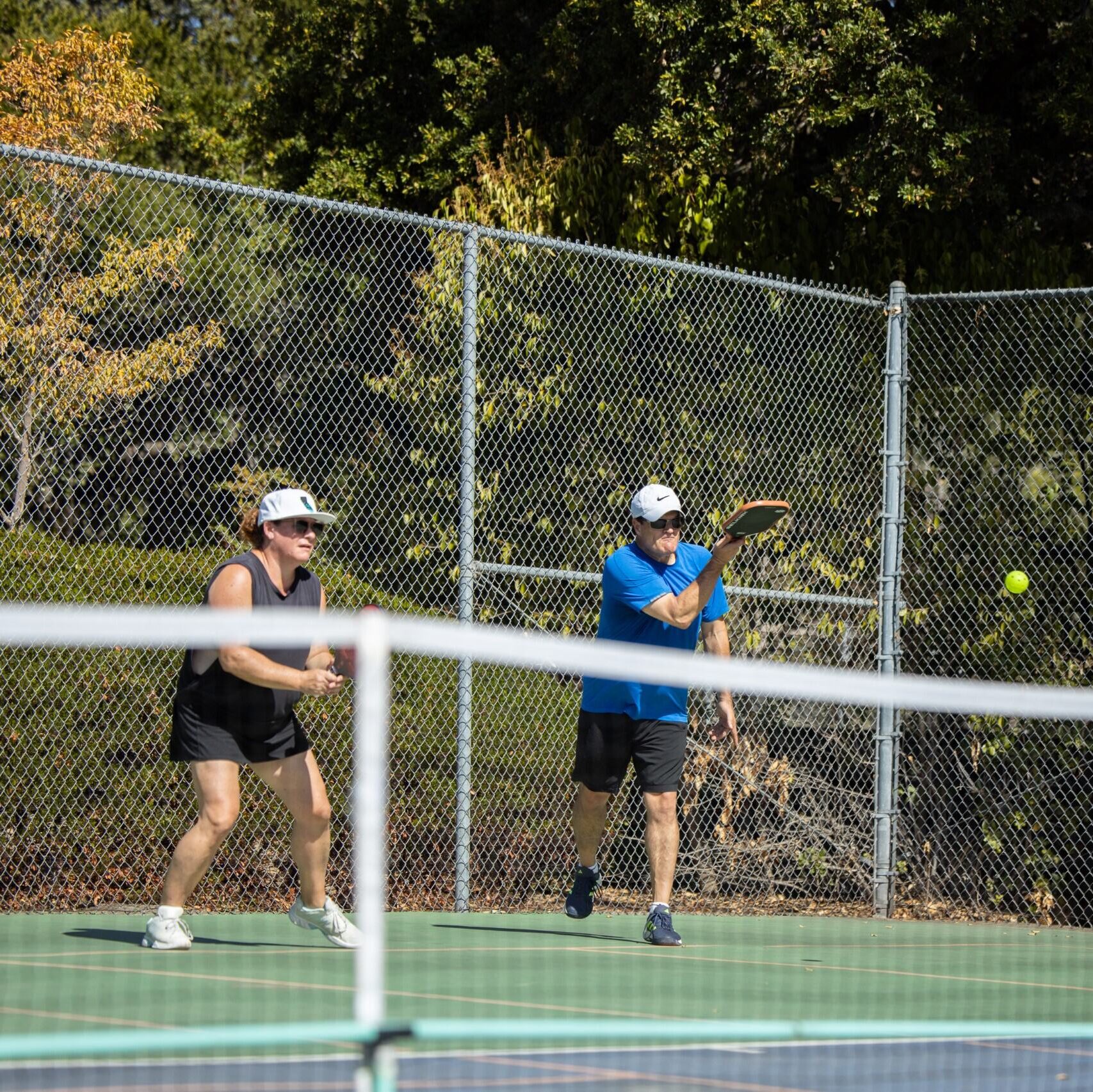 pickleball players hitting a ball