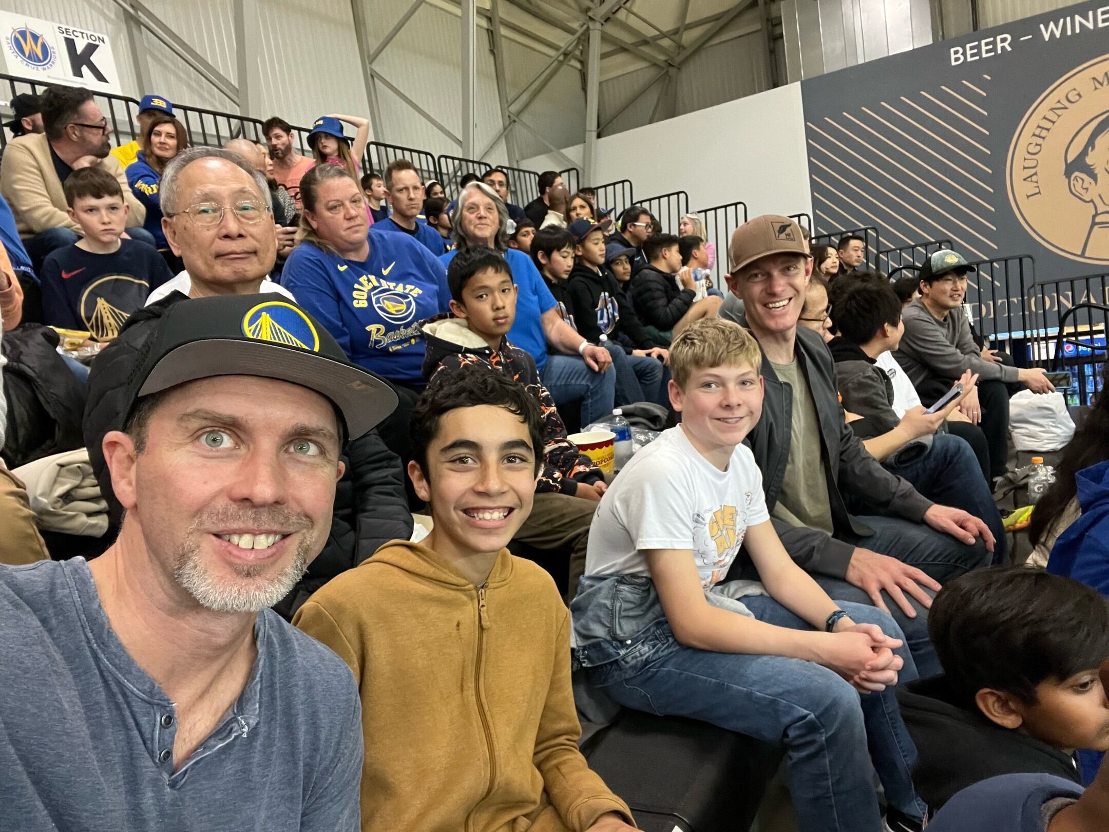 Families sitting in stands of lgsr basktball academy event