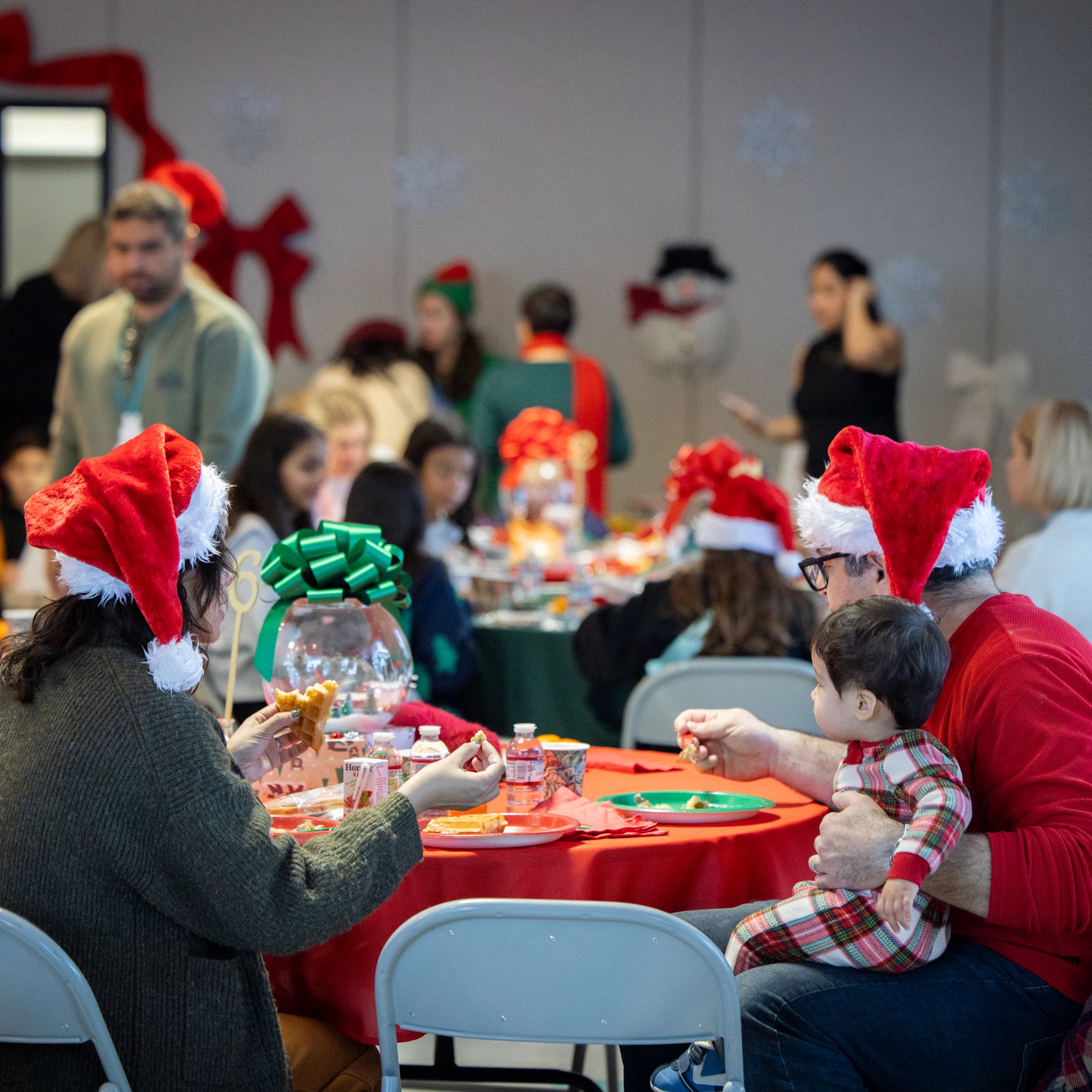parents with kids at breakfast with santa