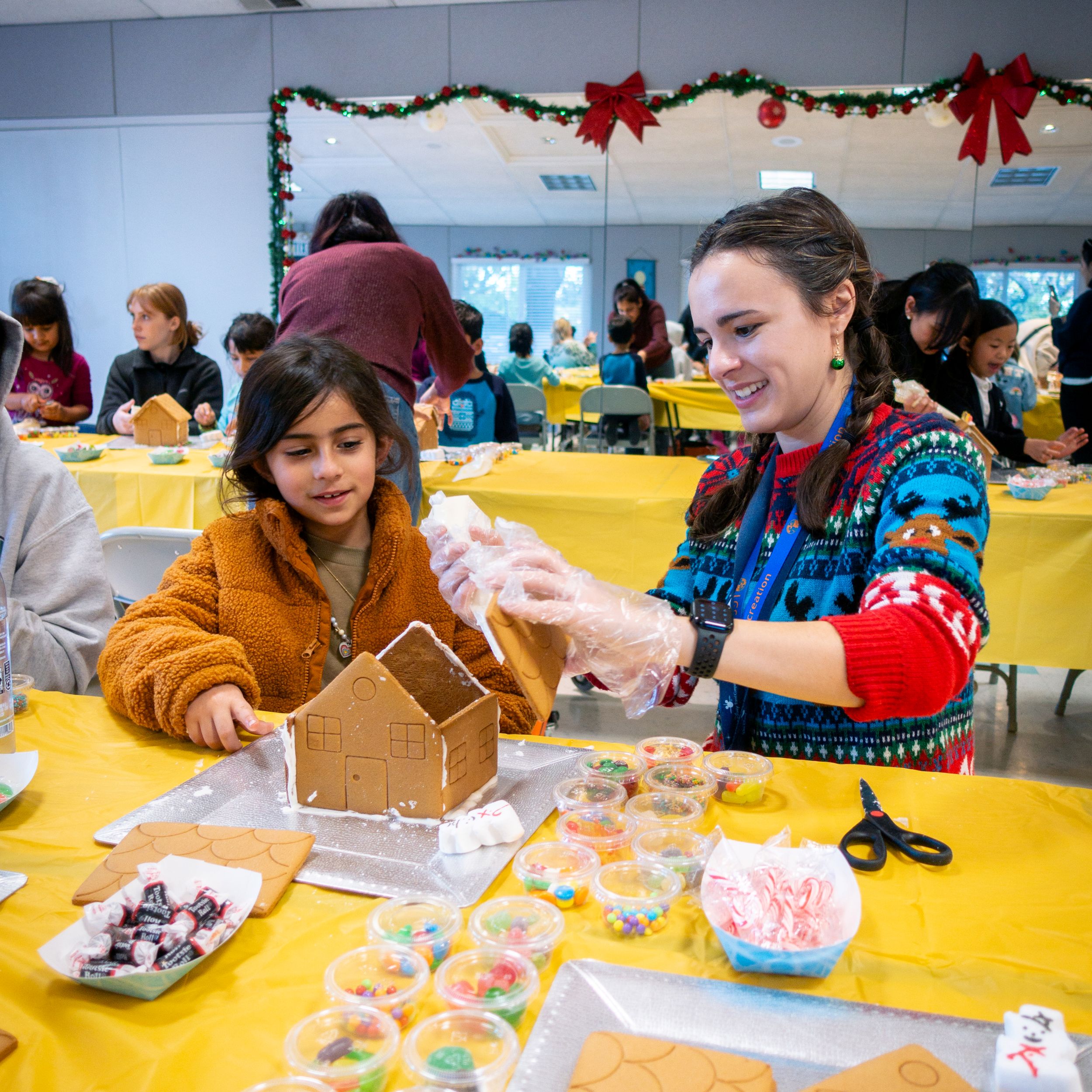 Kid and staff at gingerbread holiday event