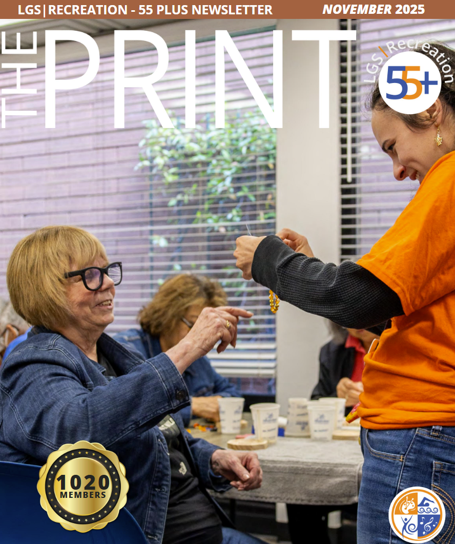 November print cover, Brooke looking at jewelry made by a participant