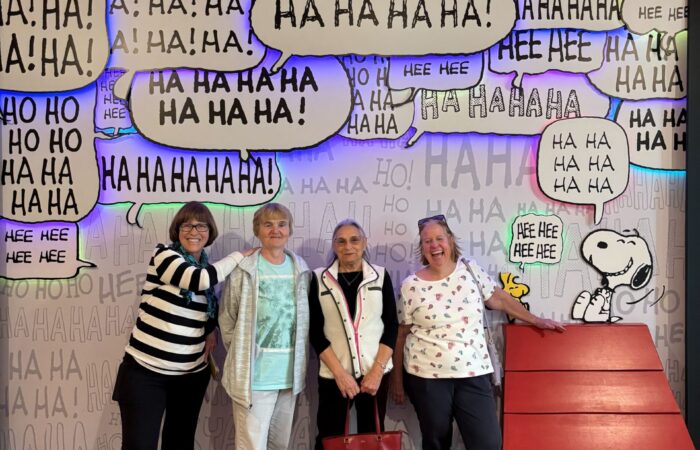 Charles Schulz 4 Seniors with a Peanuts comic picture wall